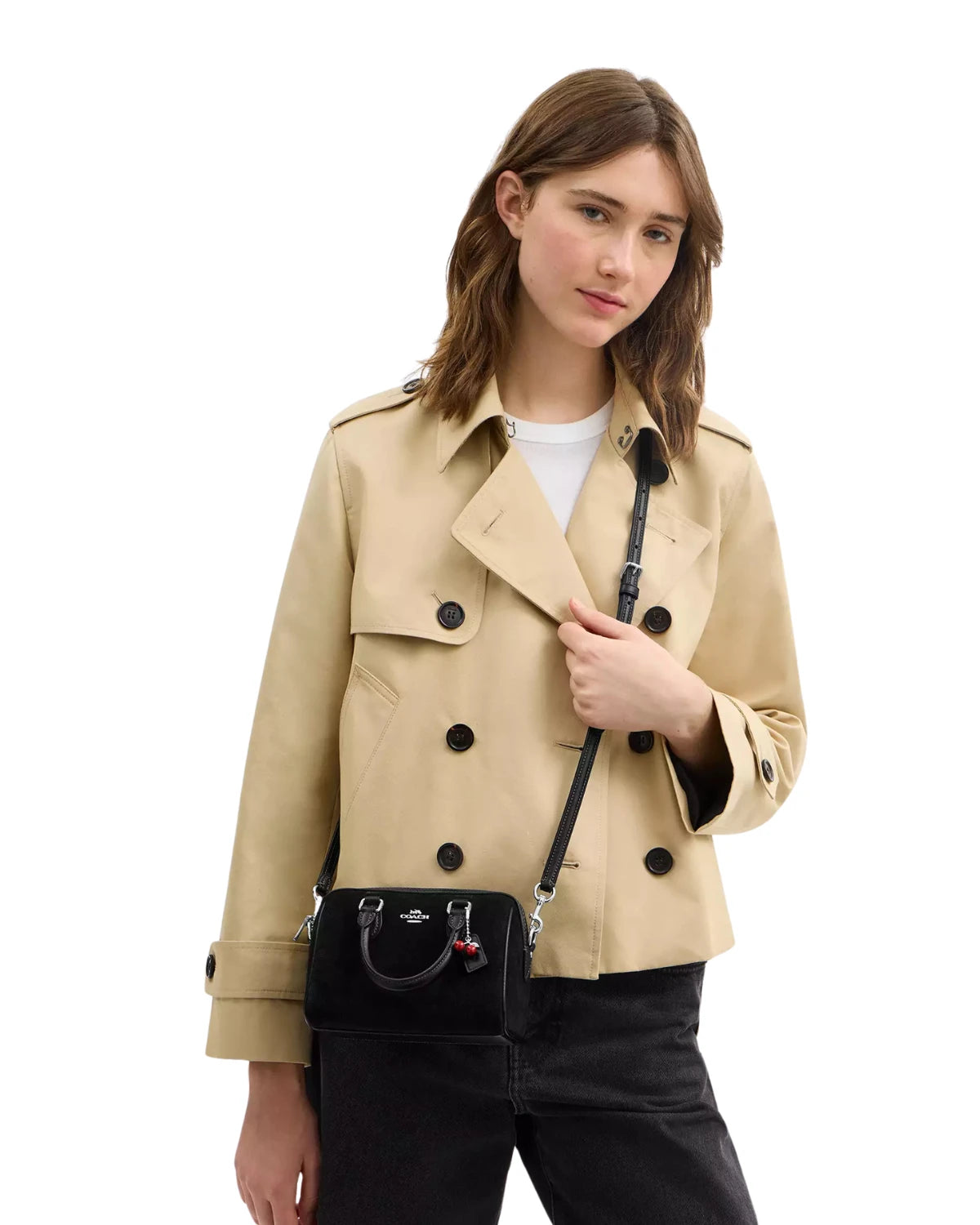 Woman wearing the Coach Mini Rowan Crossbody Bag with Cherry Charm CDC93 as a crossbody, styled for an everyday outfit