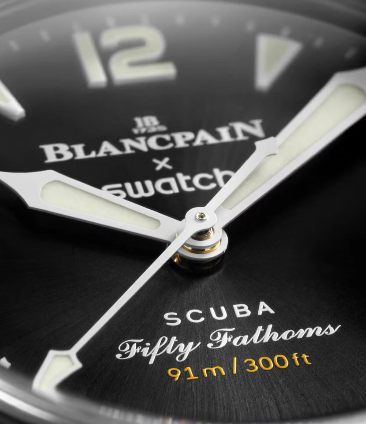 Close-up of the Blancpain X Swatch Ocean of Storms SO35B400 black sunbrushed dial showing Super-LumiNova hour indexes, hands and date window