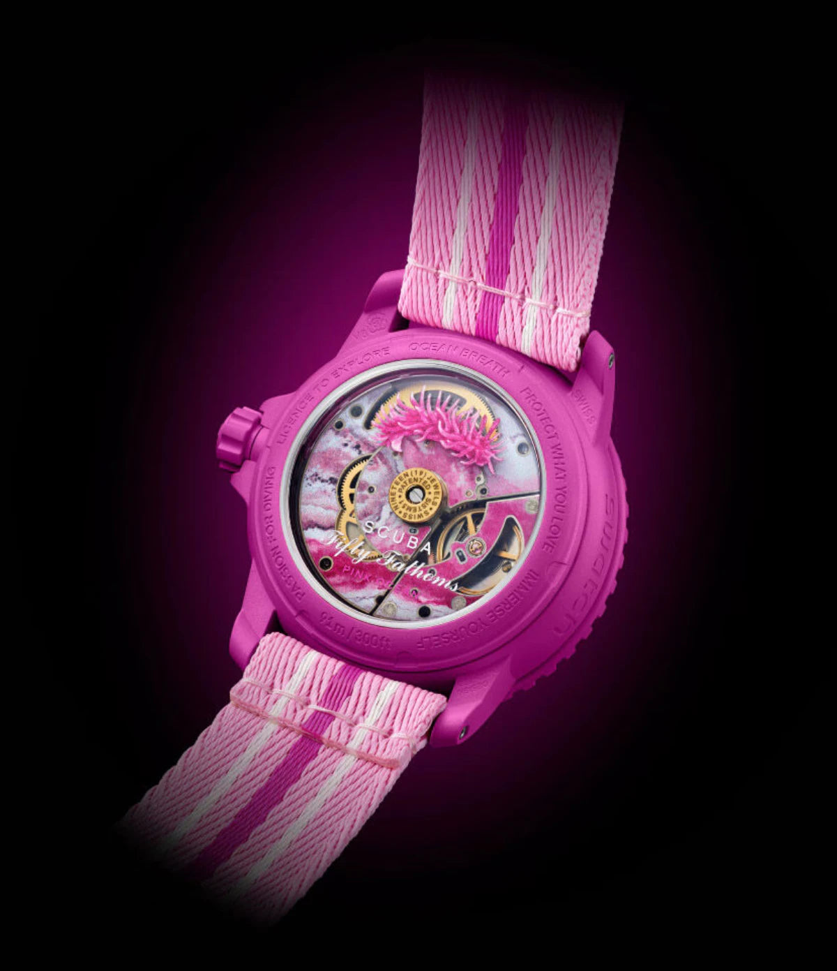 Transparent sapphire caseback of the Blancpain X Swatch Pink Ocean SO35P400 showing the SISTEM51 mechanical movement with pink-hued water and Ceratodoris rosacea nudibranch print
