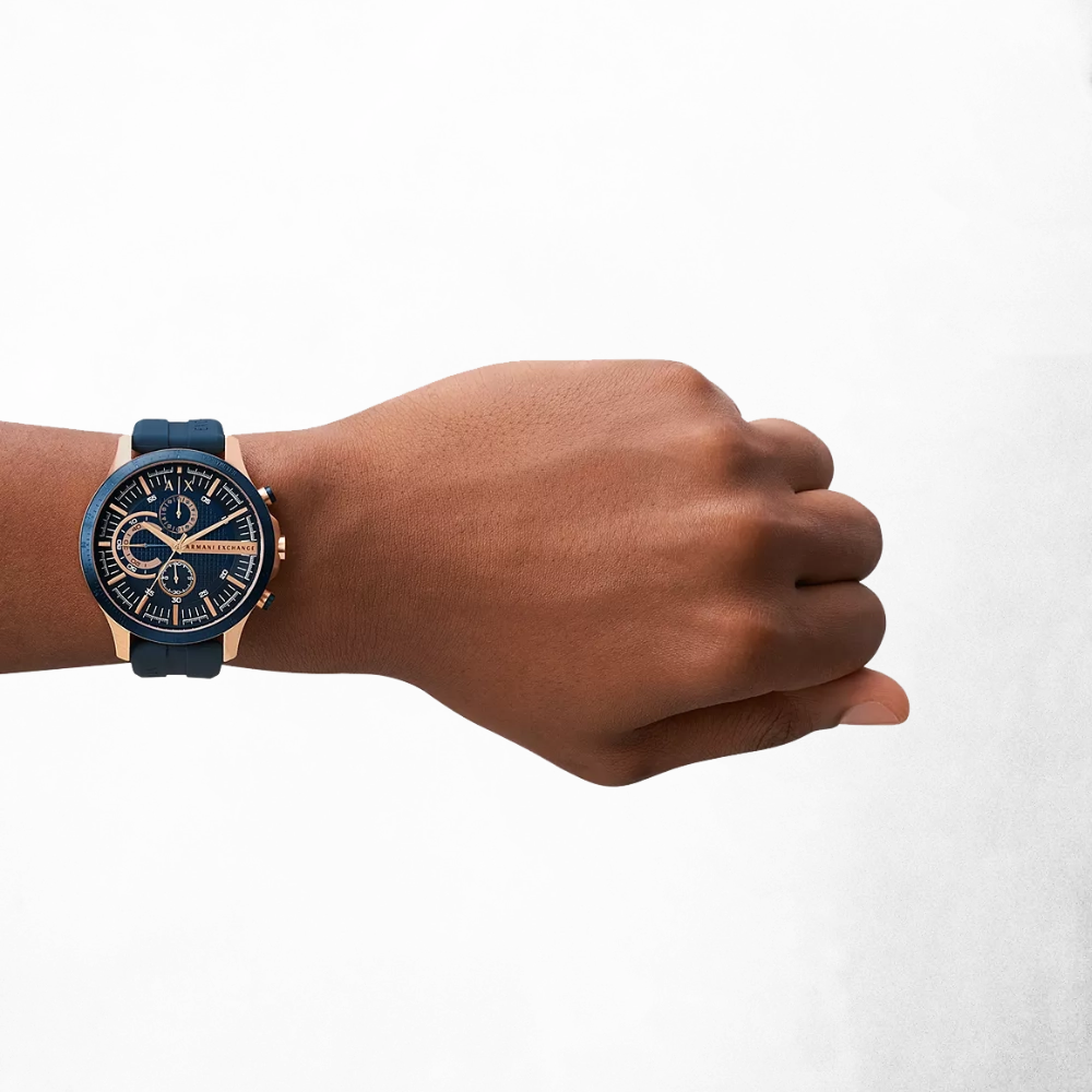 Close-up of a man's wrist wearing the Armani Exchange AX2440, emphasizing the watch's bold design and comfortable silicone strap.