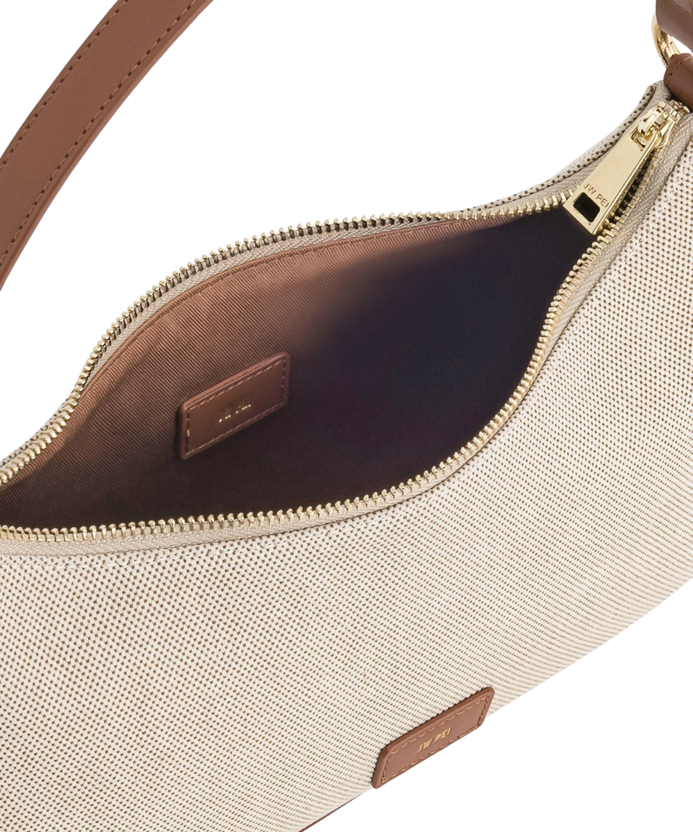 Lifestyle view of the JW PEI Lily brown canvas bag styled for shoulder wear