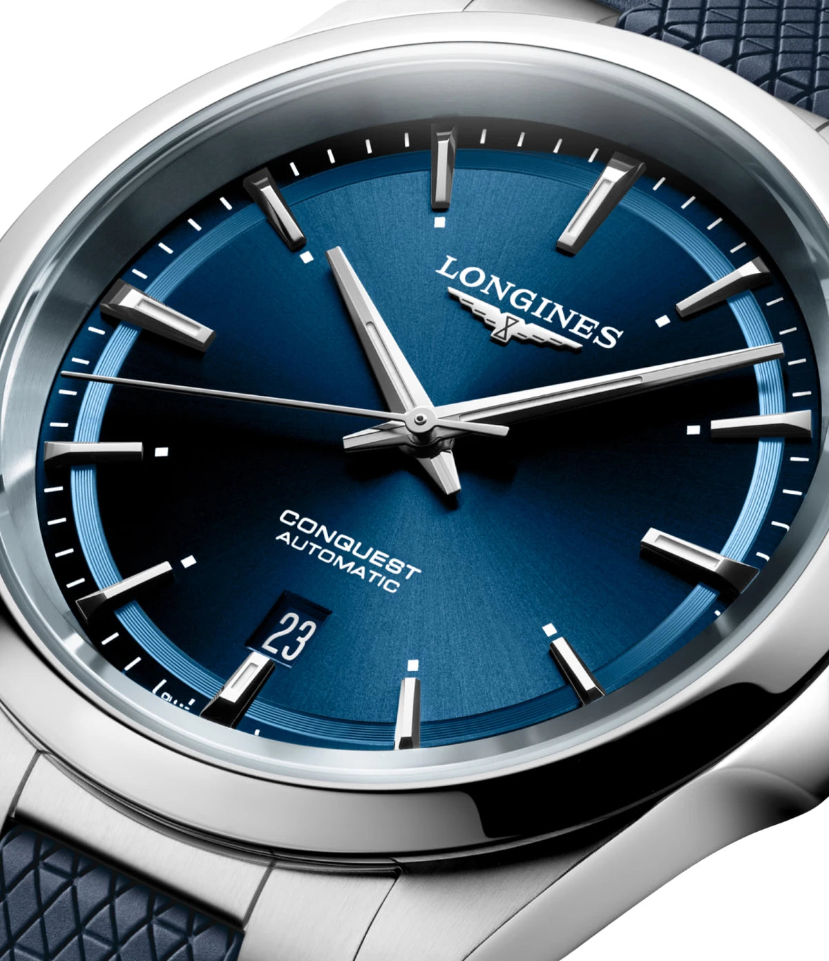 Close-up of a Longines Conquest Automatic watch with a deep blue dial, silver-toned case, and a textured dark blue strap.