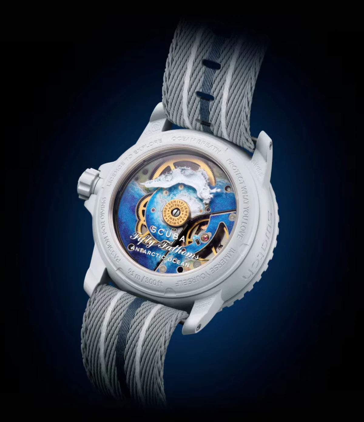 Transparent sapphire caseback of the Blancpain X Swatch Antarctic Ocean SO35S100 showing the SISTEM51 mechanical movement with Antarctic Ocean illustration and Tritoniella Belli nudibranch print