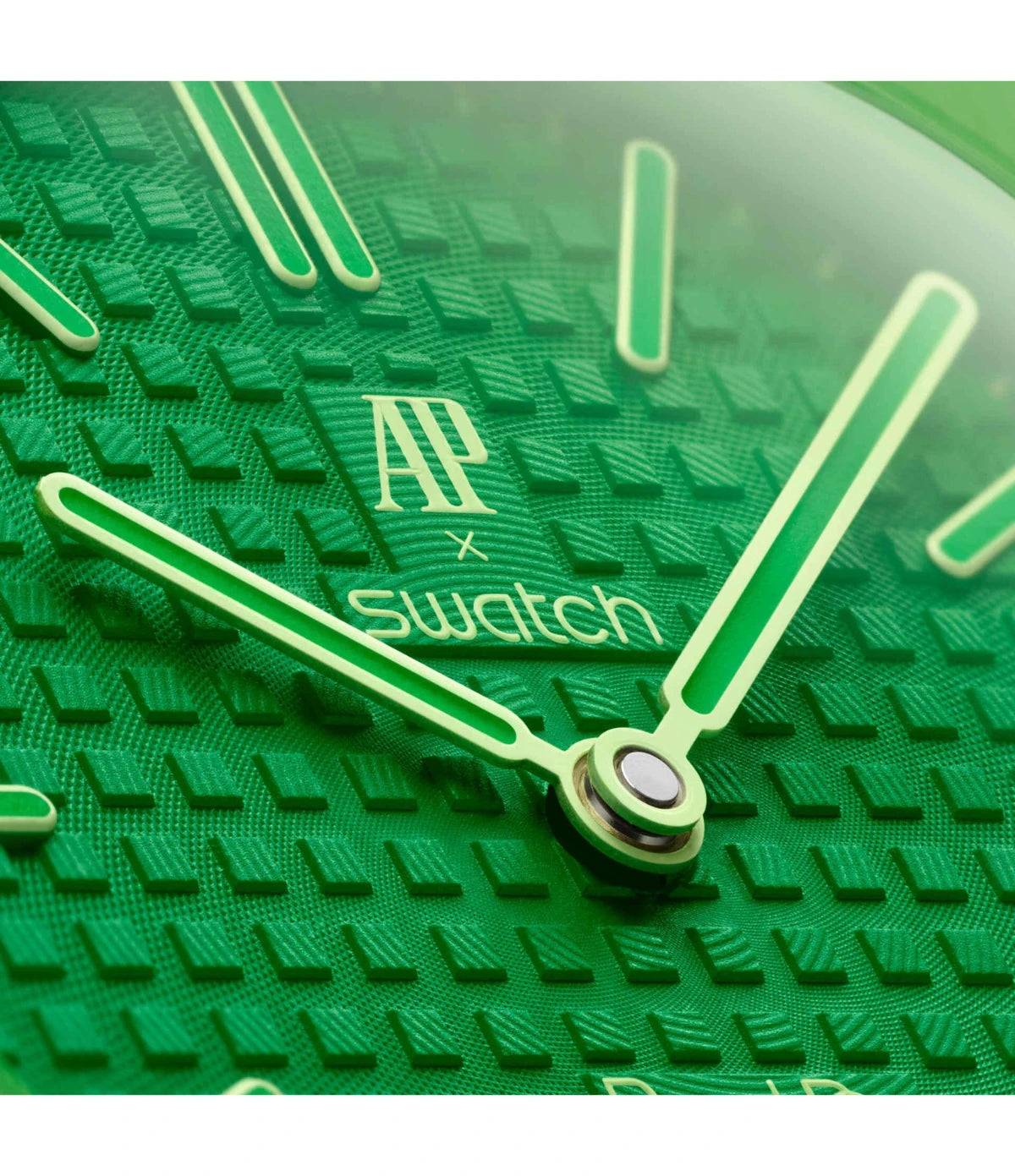 Close-up of the green tapisserie dial on the Swatch x Audemars Piguet Royal Pop Green Eight SSX03G100N showing hour markers and hands with blue Super-LumiNova glow