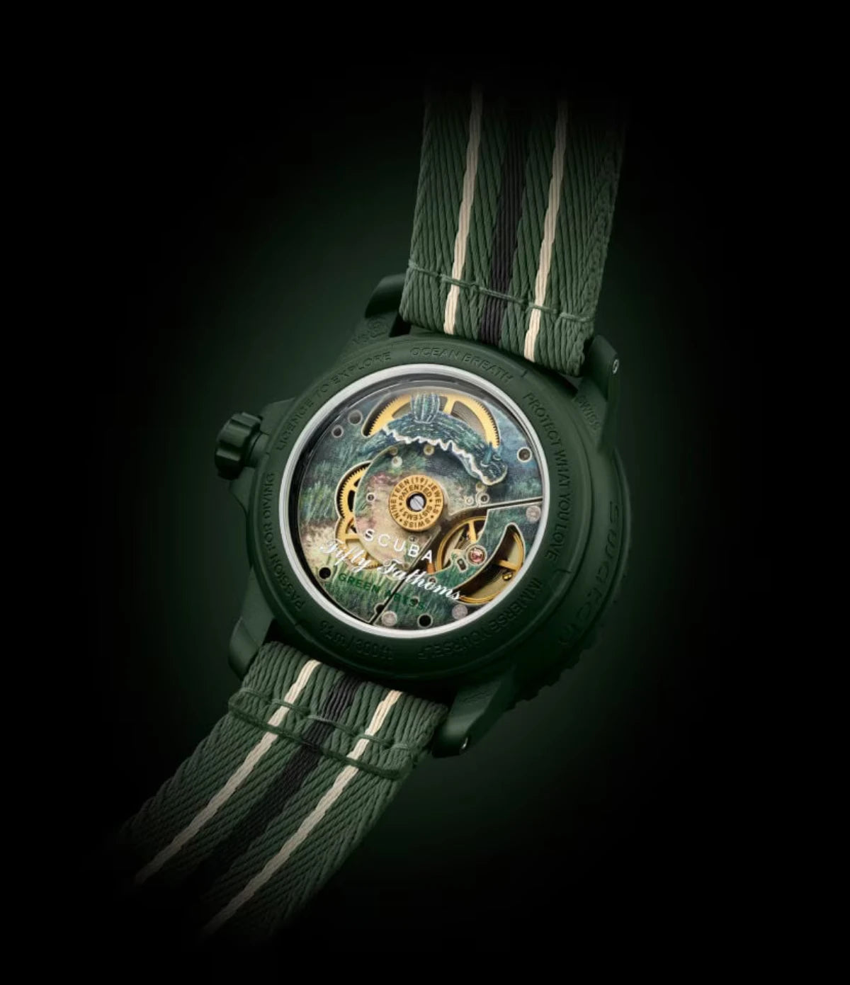 Transparent sapphire caseback of the Blancpain X Swatch Green Abyss SO35G100 showing the SISTEM51 mechanical movement with ocean floor and Felimare picta nudibranch print