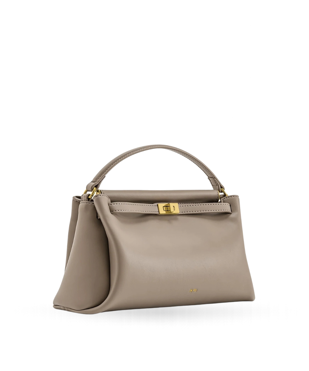 Side profile of the JW PEI Carmen bag in apricot, showing its structured silhouette and strap design