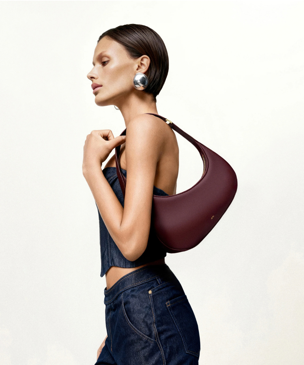 Lifestyle view of the JW PEI Harlee claret bag styled for shoulder wear